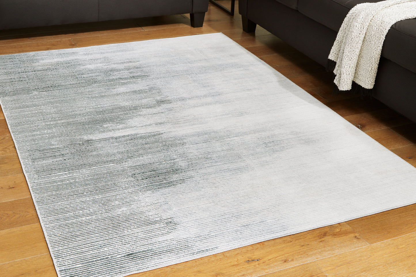 Auburndale Furniture Outlet - Ashley Furniture - Milset Rug - 8'1" x 10' Washable Rug / Black/White/Gray - R406251