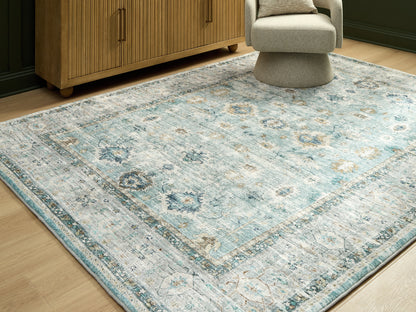 Auburndale Furniture Outlet - Ashley Furniture - Ladstoney Rug - 5' x 7' Area Rug / Teal/Beige/Ochre - R407502
