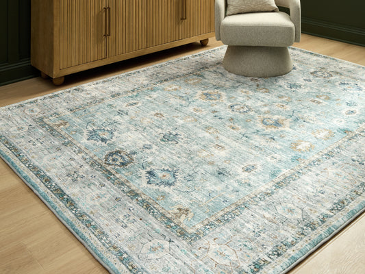 Auburndale Furniture Outlet - Ashley Furniture - Ladstoney Rug - 5' x 7' Area Rug / Teal/Beige/Ochre - R407502