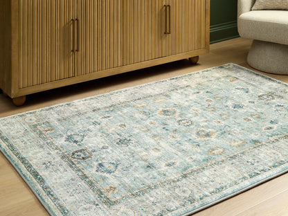 Auburndale Furniture Outlet - Ashley Furniture - Ladstoney Rug - 5' x 7' Area Rug / Teal/Beige/Ochre - R407502