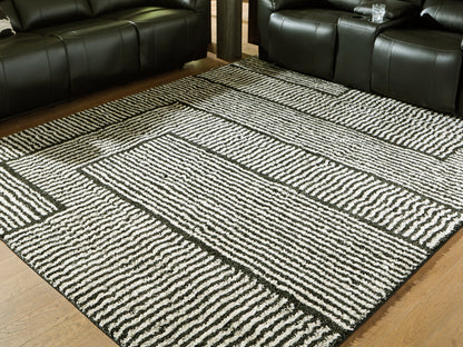 Auburndale Furniture Outlet - Ashley Furniture - Kurtmen Rug - 7'10" x 9'10" Area Rug / Black/Ivory - R407591